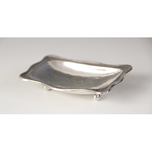 104 - A George V silver pin dish, Omar Ramsden, London 1922, of rectangular form with shaped borders on fo... 