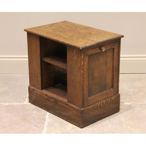 1176 - A mid 20th century oak magazine table/cabinet bearing a Gordon Russell label, the rectangular moulde... 