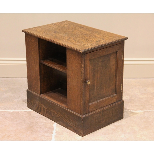 1176 - A mid 20th century oak magazine table/cabinet bearing a Gordon Russell label, the rectangular moulde... 