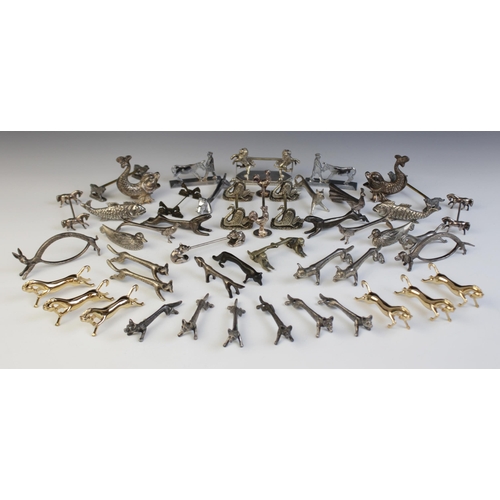 125 - A collection of novelty animal knife rests, including six silver coloured foxes, each 9cm long, a pa... 