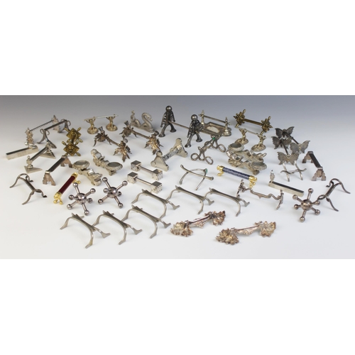 127 - A collection of 19th century and later novelty cutlery rests, including a pair of stylized thistle e... 