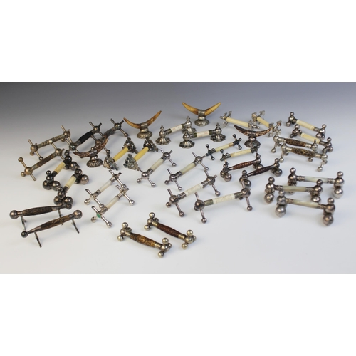 128 - A large selection of 19th century and later cutlery rests, of assorted ages, styles and sizes (Qty)