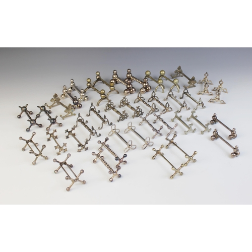 129 - A large selection of 19th century and later silver plated, EPNS and silver coloured cutlery rests, o... 