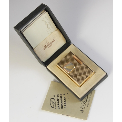 27 - A Dupont diamond set gold plated lighter, of rectangular form with engine turned decoration, applied... 