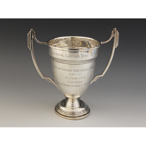 3 - A George VI silver twin-handled trophy cup, tapering bowl on stepped circular foot with angular hand... 