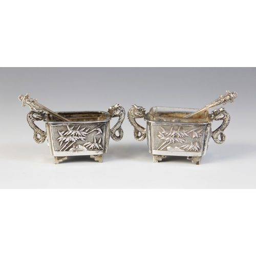 30 - A pair of Chinese silver salts, each of rectangular form with scalloped corners raised on four feet,... 