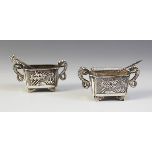 30 - A pair of Chinese silver salts, each of rectangular form with scalloped corners raised on four feet,... 
