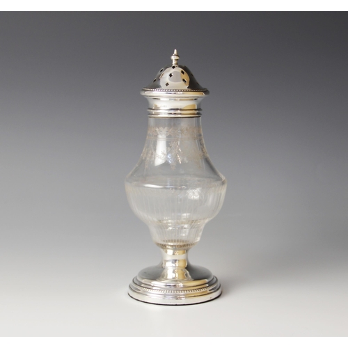 75 - A George V silver mounted glass sugar caster, of baluster form with floral swag decoration, weighted... 