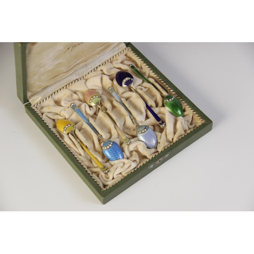 89 - A cased set of six Danish enamelled silver gilt coffee spoons by Marius Hammer, each with engine tur... 