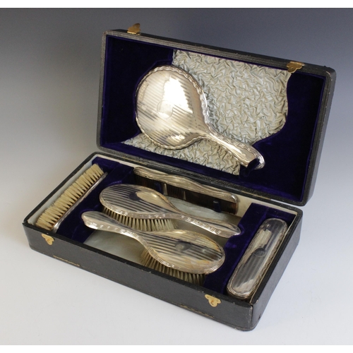 16 - An Art Deco silver and enamel backed dressing table set, A & J Zimmerman Ltd, 1930-31,  comprising; ... 