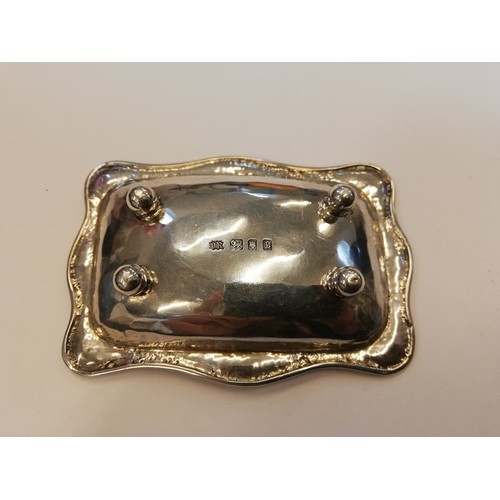 104 - A George V silver pin dish, Omar Ramsden, London 1922, of rectangular form with shaped borders on fo... 