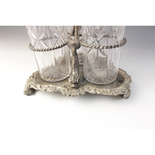 109 - A late 19th century silver plated triple decanter stand, trefoil base with cast rim and shell feet, ... 