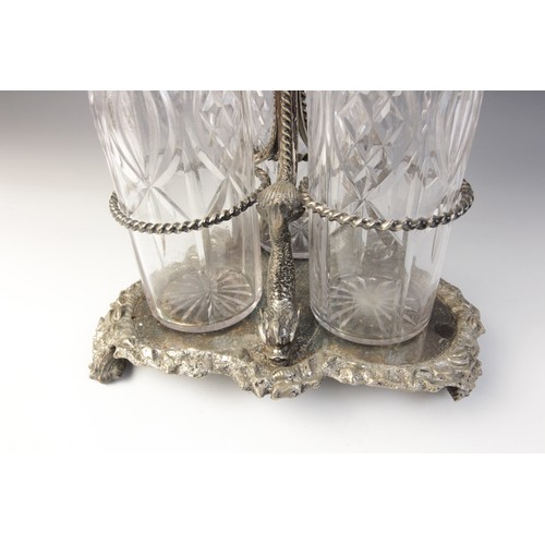 109 - A late 19th century silver plated triple decanter stand, trefoil base with cast rim and shell feet, ... 