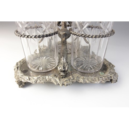 109 - A late 19th century silver plated triple decanter stand, trefoil base with cast rim and shell feet, ... 