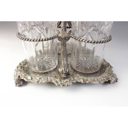 109 - A late 19th century silver plated triple decanter stand, trefoil base with cast rim and shell feet, ... 