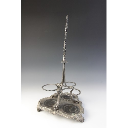 109 - A late 19th century silver plated triple decanter stand, trefoil base with cast rim and shell feet, ... 