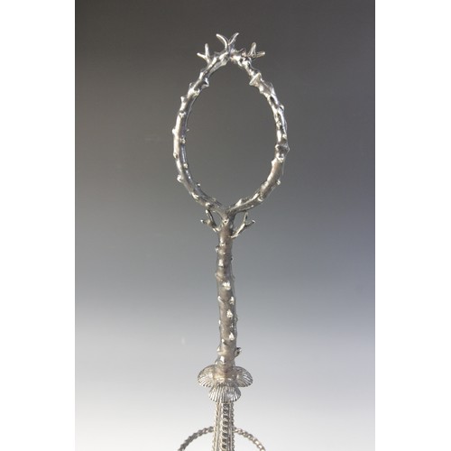 109 - A late 19th century silver plated triple decanter stand, trefoil base with cast rim and shell feet, ... 