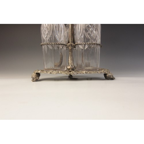 109 - A late 19th century silver plated triple decanter stand, trefoil base with cast rim and shell feet, ... 