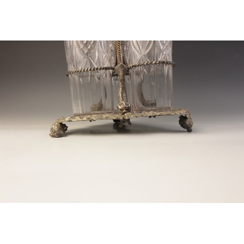 109 - A late 19th century silver plated triple decanter stand, trefoil base with cast rim and shell feet, ... 