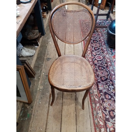 1184 - A matched set of six Thonet type bentwood chairs, early 20th century, each with a cordiform rattan b... 