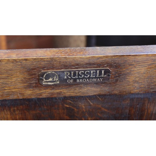 1176 - A mid 20th century oak magazine table/cabinet bearing a Gordon Russell label, the rectangular moulde... 