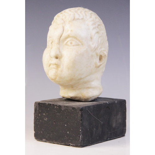 103 - A carved marble head, depicting a young boy with distinctive hair details, 15m high, upon a plinth b... 