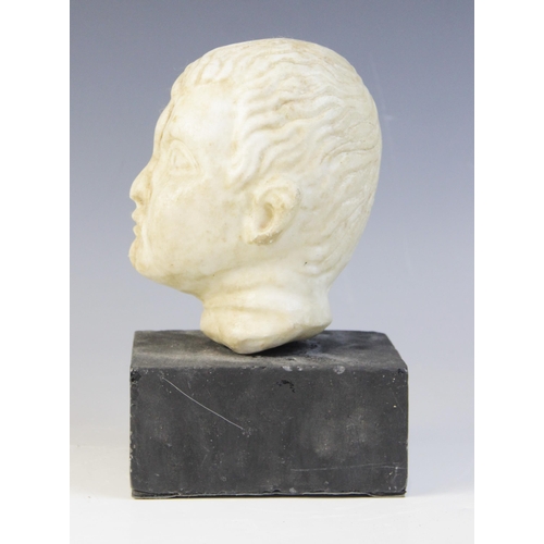 103 - A carved marble head, depicting a young boy with distinctive hair details, 15m high, upon a plinth b... 