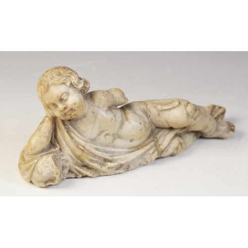 107 - A carved marble fragment depicting a reclining putto with draped material, 22cm long, 10cm high (at ... 