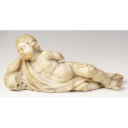 107 - A carved marble fragment depicting a reclining putto with draped material, 22cm long, 10cm high (at ... 