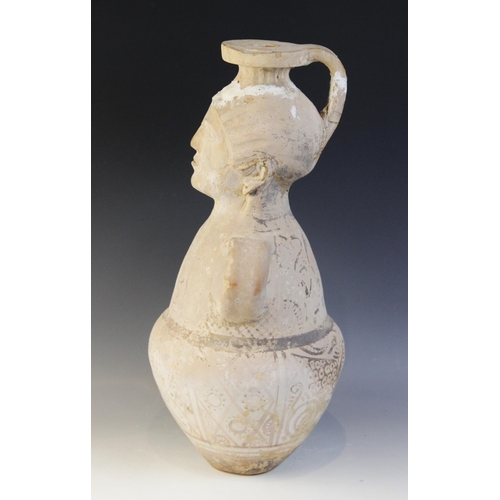 108 - A terracotta water jug, the amphora form jug with loop handles, the neck modelled as a head with fla... 