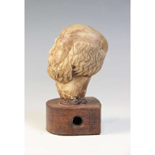 109 - A carved marble male head, 9cm high, upon a later wooden base, 12.5cm high overall (at fault)