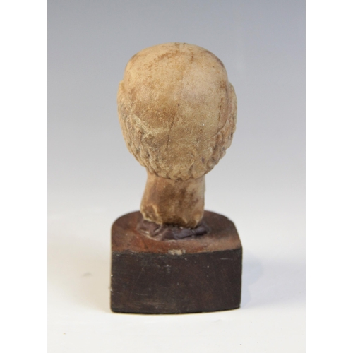 109 - A carved marble male head, 9cm high, upon a later wooden base, 12.5cm high overall (at fault)