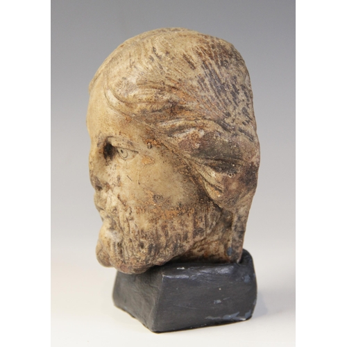 110 - A carved marble male head possibly Christ, modelled with detailed hair and beard, 11.5cm high, set t... 