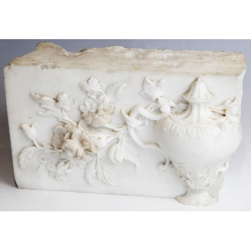 113 - A marble carving fragment, depicting a classical urn within a floral surround, 27.5cm W x 18cm L x 7... 