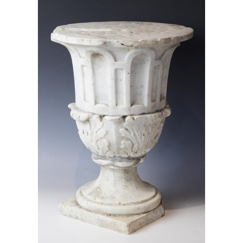 116 - A marble plinth, the urn base with relief carved acanthus leaves to body upon a stepped spreading fo... 