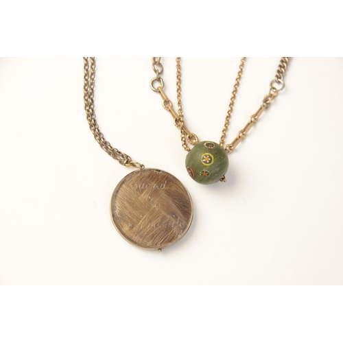 12 - A Victorian memorial pendant, the transparent circular pendant containing braided hair, beaded monog... 