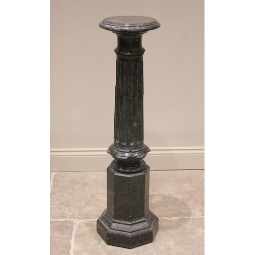 169 - A variegated green marble pedestal, the circular top with a leaf carved edge upon a fluted column an... 