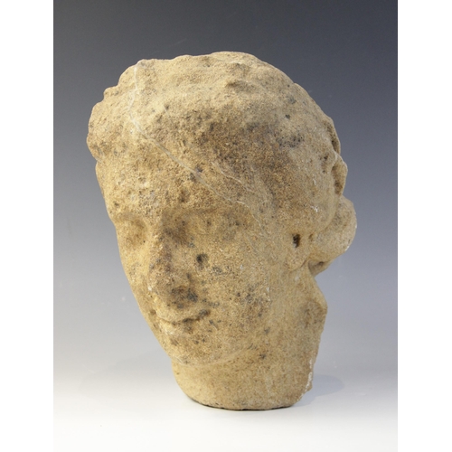 164 - A carved stone head in the classical manner, possibly Venus, with flowing hair, 26cm high (at fault)