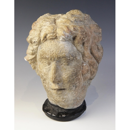 167 - A carved stone female head, in the classical manner, upon later base, 29cm high (at fault)