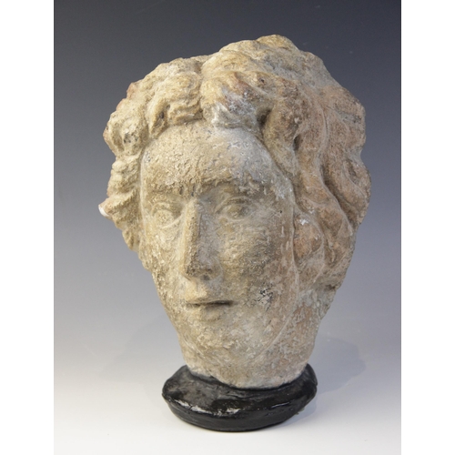 167 - A carved stone female head, in the classical manner, upon later base, 29cm high (at fault)