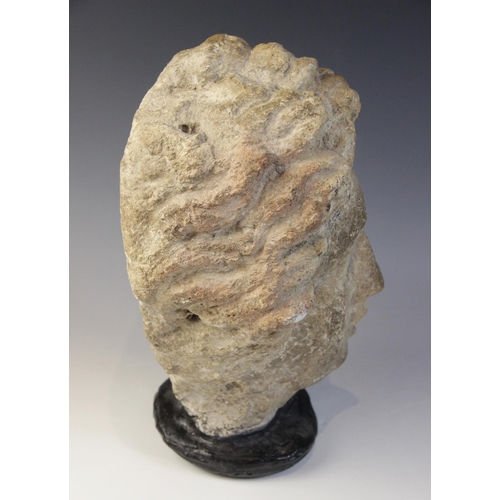 167 - A carved stone female head, in the classical manner, upon later base, 29cm high (at fault)