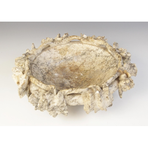 172 - A figured alabaster dish in the Grand Tour manner, the rim modelled as a pierced and relief carved g... 