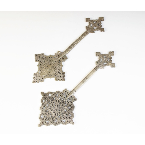 24 - * Two Ethiopian Coptic crosses, 19th century or later, each brass cross of typical reticulated form,... 