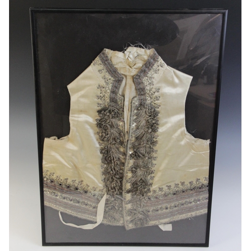 261 - A late 18th/early 19th century ivory silk satin waistcoat, decorated in silver coloured and gilt bro... 