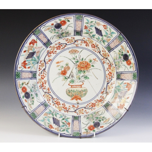 306 - A Chinese famille verte kraak type porcelain charger, 18th century, the circular charger centrally d... 