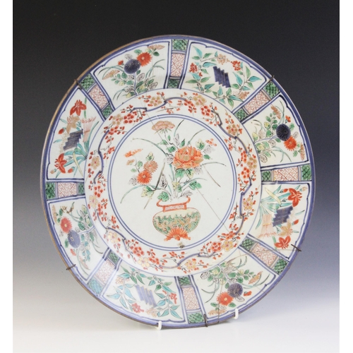 306 - A Chinese famille verte kraak type porcelain charger, 18th century, the circular charger centrally d... 