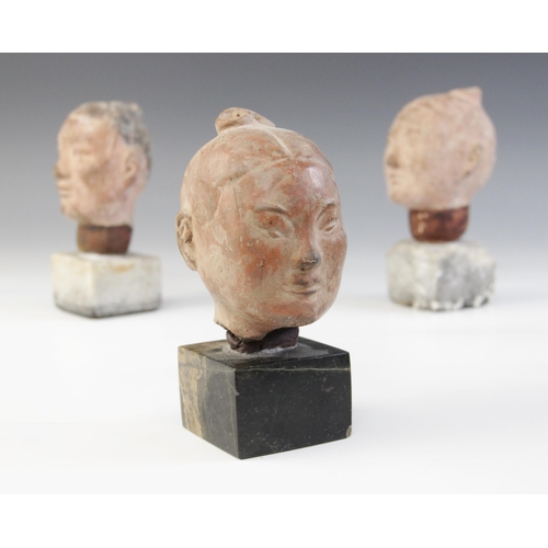 314 - Three Chinese terracotta heads, possibly Han dynasty, each buff glazed exterior with moulded feature... 