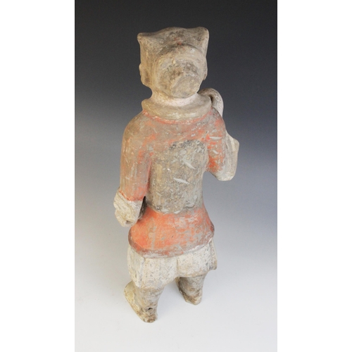 321 - A Chinese pottery warrior, possibly Han dynasty, modelled standing wearing armour and painted in bla... 