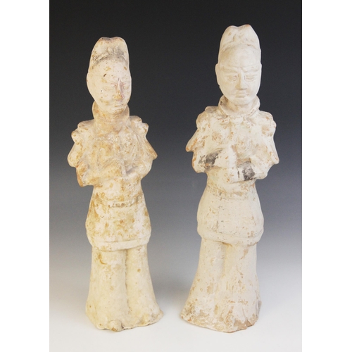 323 - Two Chinese pottery figures of warriors, possibly Tang dynasty, each modelled standing in armour wit... 