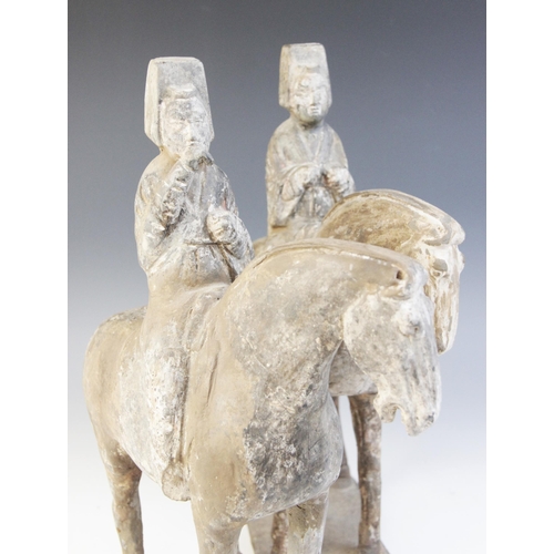 329 - Two Chinese pottery figures on horseback, possibly Tang dynasty, each horse modelled on four legs up... 